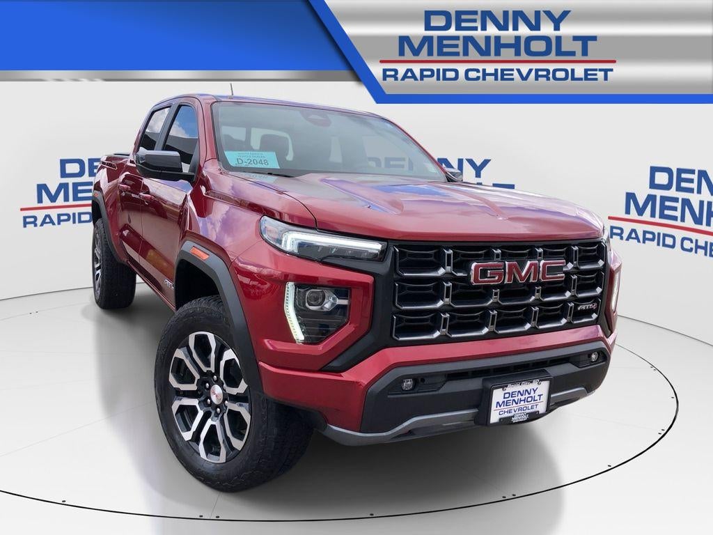2024 GMC Canyon AT4 in Volcanic Red Tintcoat — front three-quarter view